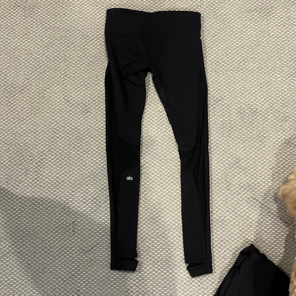 Alo black stirrup leggings. Mesh detailing along the side of the leg.